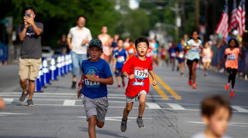 Runners sprint for the finish line during the Anthem Peachtree Junior race on 10th Street Wednesday, July 3, 2019. STEVE SCHAEFER / SPECIAL TO THE AJC