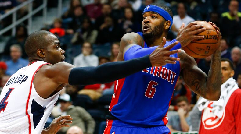 Detroit Pistons forward Josh Smith (6) looks for a open man as Atlanta Hawks forward Paul Millsap (4) defends in the second half of an NBA basketball game Friday, Nov. 21, 2014, in Atlanta. Atlanta won 99-89. (AP Photo/John Bazemore)