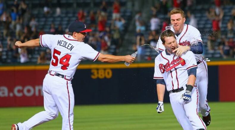 Kris Medlen, shown here squirting water on Freddie Freeman after a win last August, has always been one of the team's free spirits. (Curtis Compton/AJC)