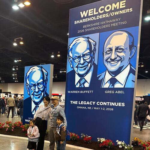 Shareholders line up to take pictures with depictions of Berkshire Hathaway's new CEO Greg Abel and Chairman Warren Buffett on Friday, May 1, 2026 in Omaha, Neb. (AP Photo/Josh Funk)