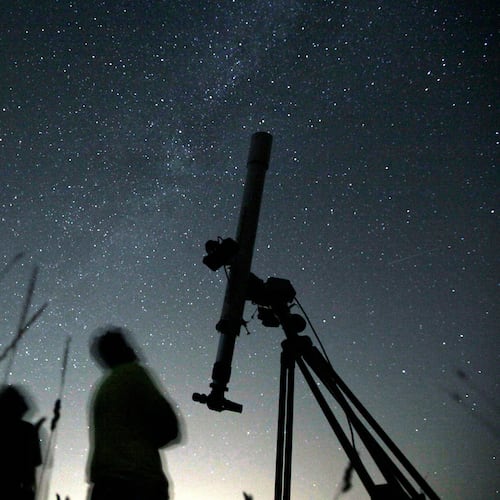 FILE - People look up to the sky from an observatory near the village of Avren, Bulgaria, Aug. 12, 2009. (AP Photo/Petar Petrov, File)
