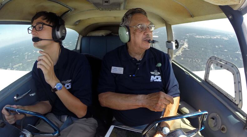 Julius Alexander supervises as his student Alex Marquardt works on a certified flight Instructor license.
