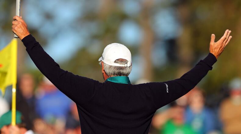Fred Couples reacts to the gallery as he steps onto the 18th green. His approach shot brought a roar of appreciation from the crowd and he made his birdie putt. CURTIS COMPTON/ AJC