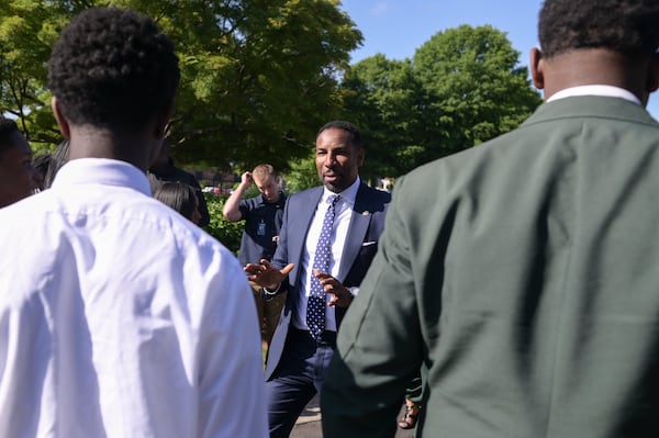 Mayor Andre Dickens chats with students from Drew Charter School in Atlanta during the grand reopening ceremony of The Villages of Eastlake on Monday, May 9, 2022.  (Natrice Miller / natrice.miller@ajc.com)