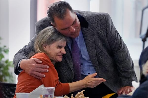Everett, Mass. Mayor Carlo DeMaria embraces resident Pamela Mavilio while visiting a senior luncheon following a bingo game at the Connolly Center, Monday, Jan. 13, 2025, in Everett. (AP Photo/Charles Krupa)