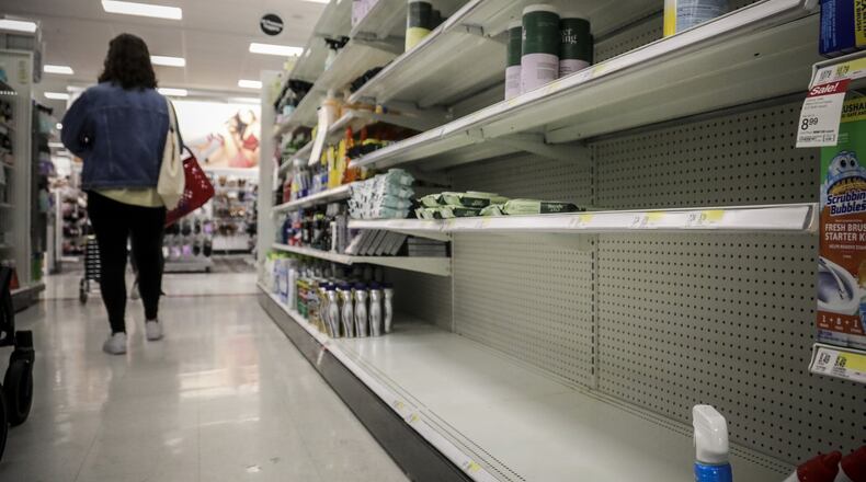 Shelves emptied of disinfectant wipes await restocking as fears grow around coronavirus. Around the country, legions of nervous hoarders are stocking up on canned goods, frozen dinners, toilet paper and cleaning products. Such hoarding is expected to last for weeks and has created big challenges for discounters and grocery stores. (Photo: Bebeto Matthews/ Associated Press)