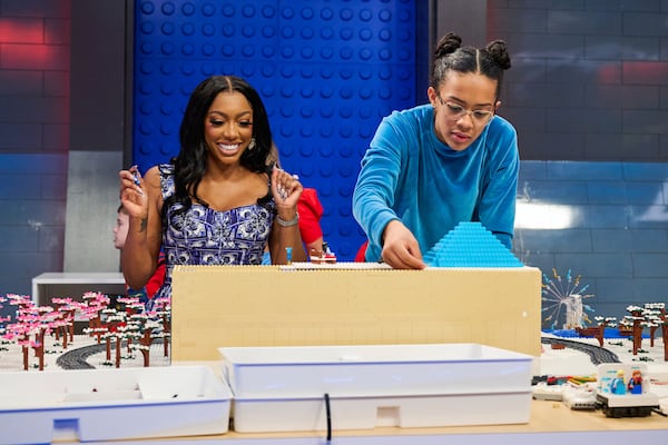 Celebrity mentor Porsha Williams (left) and contestant Zoe team up in the “Lego Masters Jr., series premiere episode "Disney Train Ride." (Tom Griscom/Fox Media LLC)