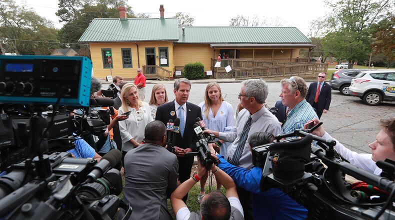 Members of the news media surround then-Secretary of State Brian Kemp, the Republican candidate for Georgia governor, after he cast his vote Nov. 6, 2018, at the Winterville Train Depot. The governor, now self-quarantining after close contact with somebody who has COVID-19, would violate Centers for Disease Control and Prevention guidelines if he voted in person on Tuesday. He has asked for an absentee ballot. Curtis Compton/ccompton@ajc.com