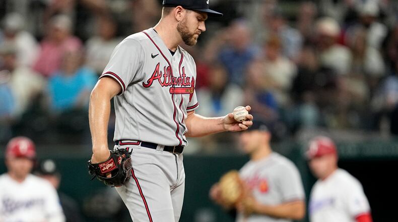Atlanta Braves relief pitcher Dylan Lee stands on the mound looking at the ball as he works against the Texas Rangers in the seventh inning of a baseball game, Tuesday, May 16, 2023, in Arlington, Texas. (AP Photo/Tony Gutierrez)
