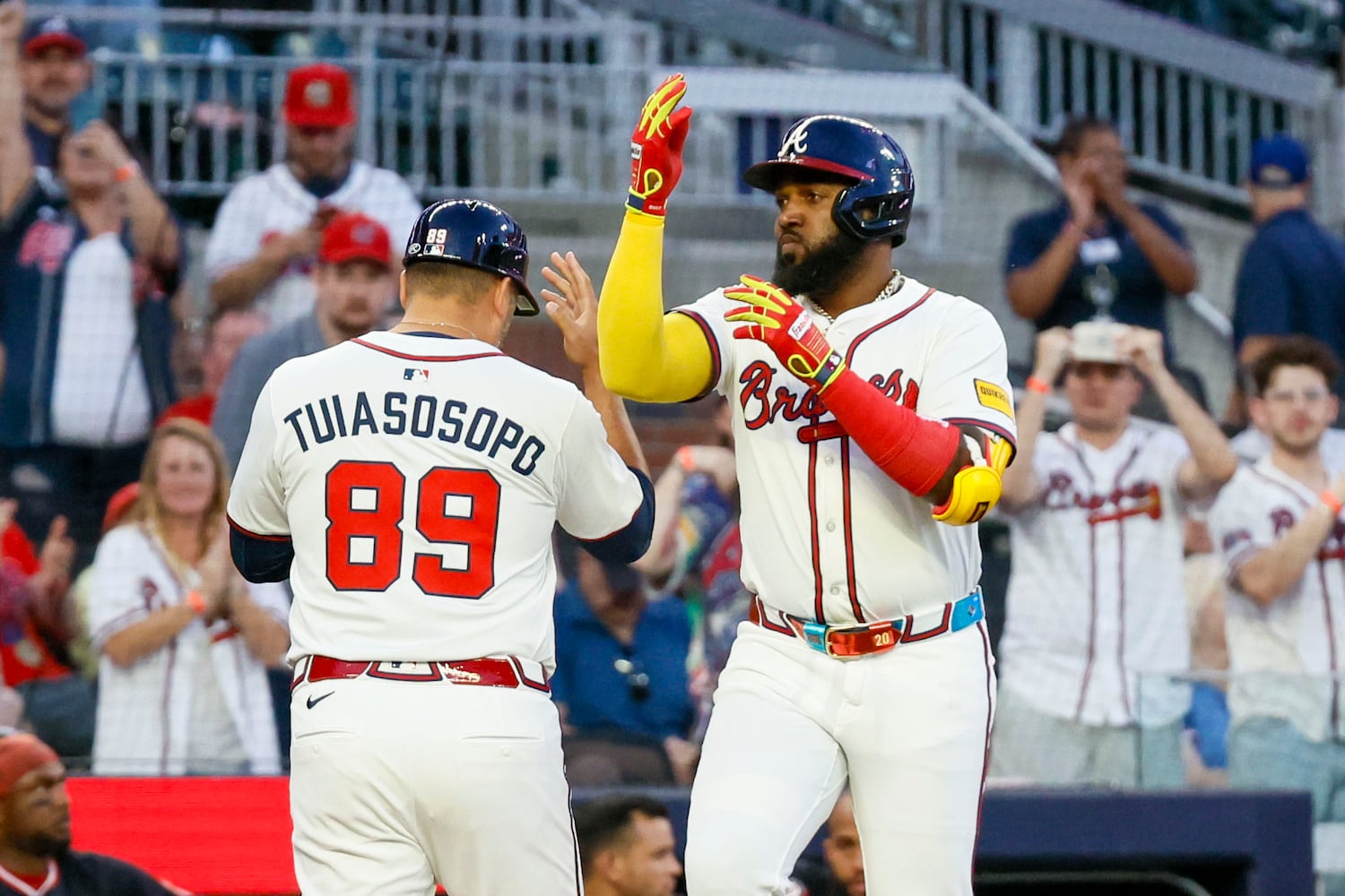 Atlanta Braves designated hitter Marcell Ozuna (20) celebrates with Atlanta Braves third base coach Matt Tuiasosopo (89) after hitting a solo home run during the fifth inning against the Washington Nationals on Monday, May 12, 2025, in Atlanta.  
(Miguel Martinez/ AJC)