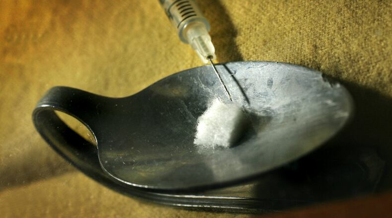 A needle and spoon a user would use to prepare heroin for injection is seen in a display at the Montgomery County Crime Lab. Staff photo by Chris Stewart