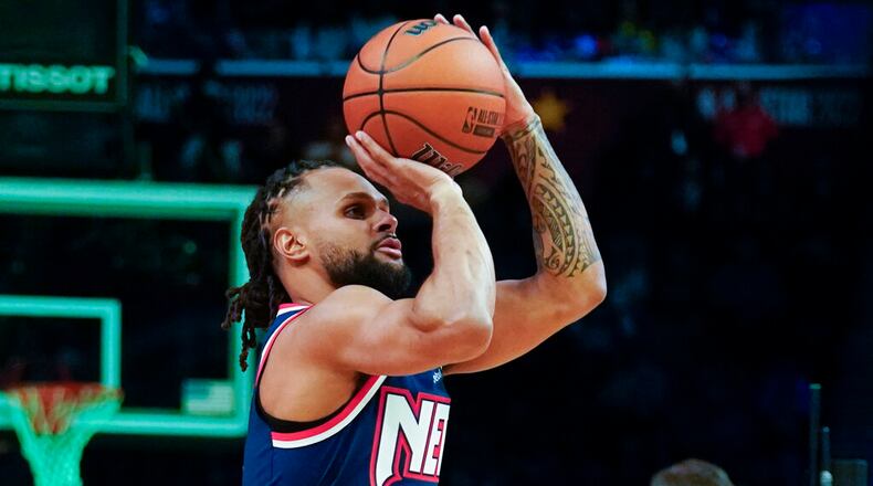 Brooklyn Nets Patty Mills shoots during the three-point shot part of the skills challenge competition, part of NBA All-Star basketball game weekend, Saturday, Feb. 19, 2022, in Cleveland. (AP Photo/Charles Krupa)