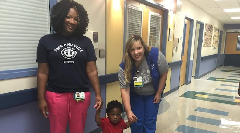 Belinda Williams, left, and coworker Stephany Melton stand with Ethan, the little boy they resuscitated during dinner at a restaurant. Photo courtesy of Belinda Williams.