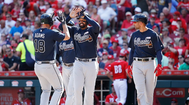 CINCINNATI, OH - JUNE 03: Matt Adams #18 of the Atlanta Braves is congratulated by Matt Kemp #27 and Nick Markakis #22 after hitting a grand slam in the fifth inning of a game against the Cincinnati Reds at Great American Ball Park on June 3, 2017 in Cincinnati, Ohio. The Braves defeated the Reds 6-5 in 12 innings. (Photo by Joe Robbins/Getty Images)