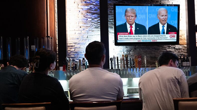 Guests at the Old Town Pour House in Chicago watch the June 27 debate between President Joe Biden and presumptive Republican nominee former President Donald Trump. (Scott Olson/Getty Images/TNS)