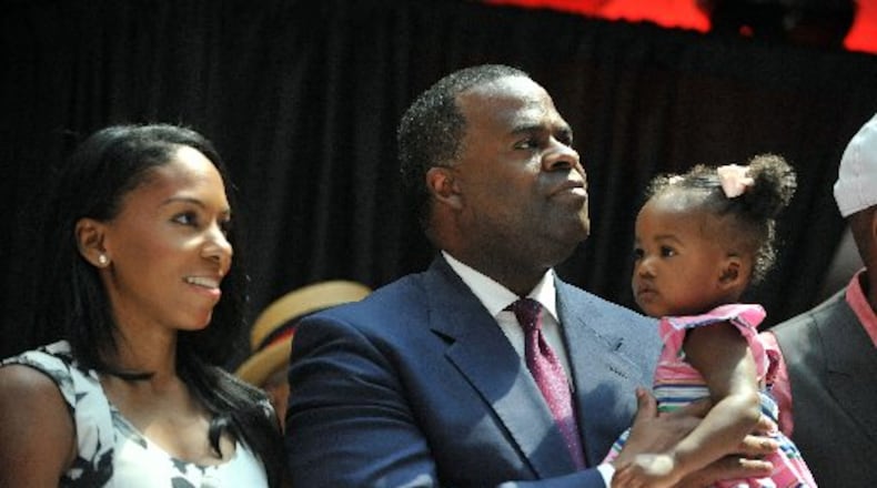 JUNE 3, 2015 ATLANTA Mayor Kasim Reed, holds his daughter, Maria Kristan, as his wife, Sarah-Elizabeth, listens during the ceremony. Mayor Kasim Reed hosts an appreciation rally in the atrium of the Atlanta City Hall. . KENT D. JOHNSON /KDJOHNSON@AJC.COM