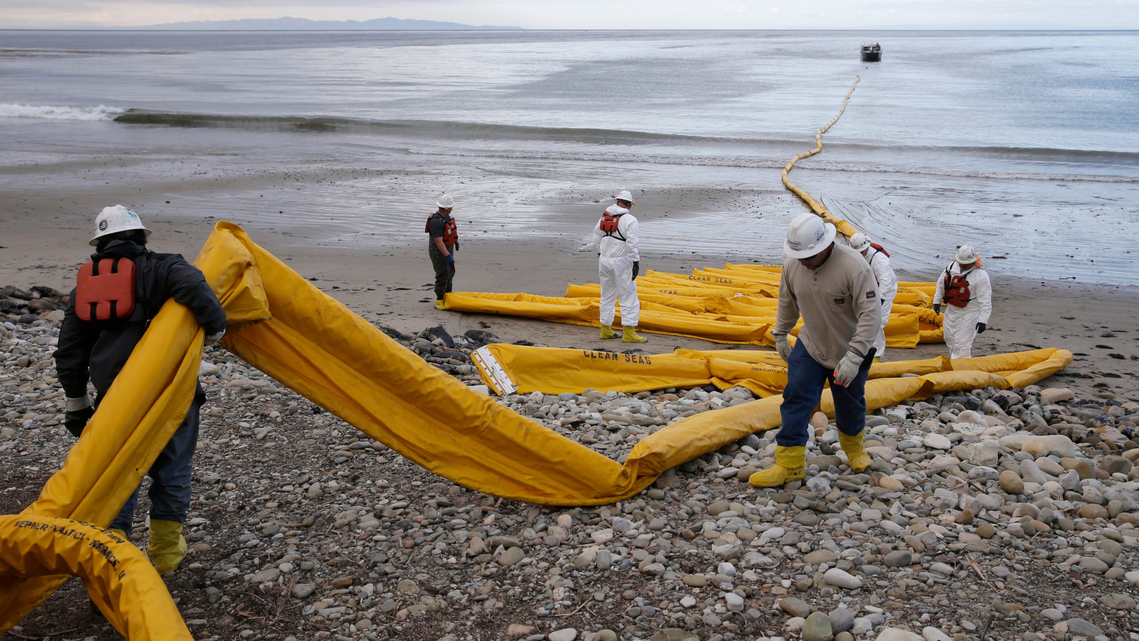 FILE - Workers prepare an oil containment boom at Refugio State Beach, north of Goleta, Calif., May 21, 2015. (AP Photo/Jae C. Hong, File)