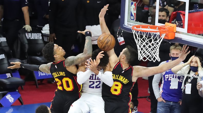 062021 Philadelphia: --CRUNCH TIME -- Atlanta Hawks forwards John Collins and Danilo Gallinari crunch Philadelphia 76ers Matisse Thybulle on his way to the basket after a pass from Ben Simmons in the final minutes of game 7 of their NBA Eastern Conference semifinals series on Sunday, Jun 20, 2021, in Philadelphia. Reluctant shooter Ben Simmons drove for what should have been a tieing dunk and passed to Thybulle who was fouled by Collins and missed one of two free throws as the Hawks pulled away for a 103-96 victory. “Curtis Compton / Curtis.Compton@ajc.com”