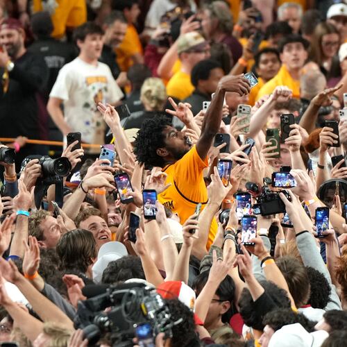 Arizona State guard Maurice Odum celebrates with fans after defeating Kansas during an NCAA college basketball game, Tuesday, March 3, 2026, in Tempe, Ariz. (AP Photo/Rick Scuteri)