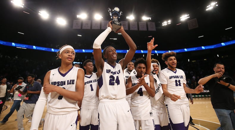 March 10, 2018 - Atlanta, Ga: Upson-Lee guard Tye Fagan (24) holds the state championship trophy up as he celebrates with teammates after their win against St. Pius during the GHSA Class AAAA Boys State Championship at McCamish Pavilion Saturday, March 10, 2018, in Atlanta. Upson-Lee won 70-54. PHOTO / JASON GETZ