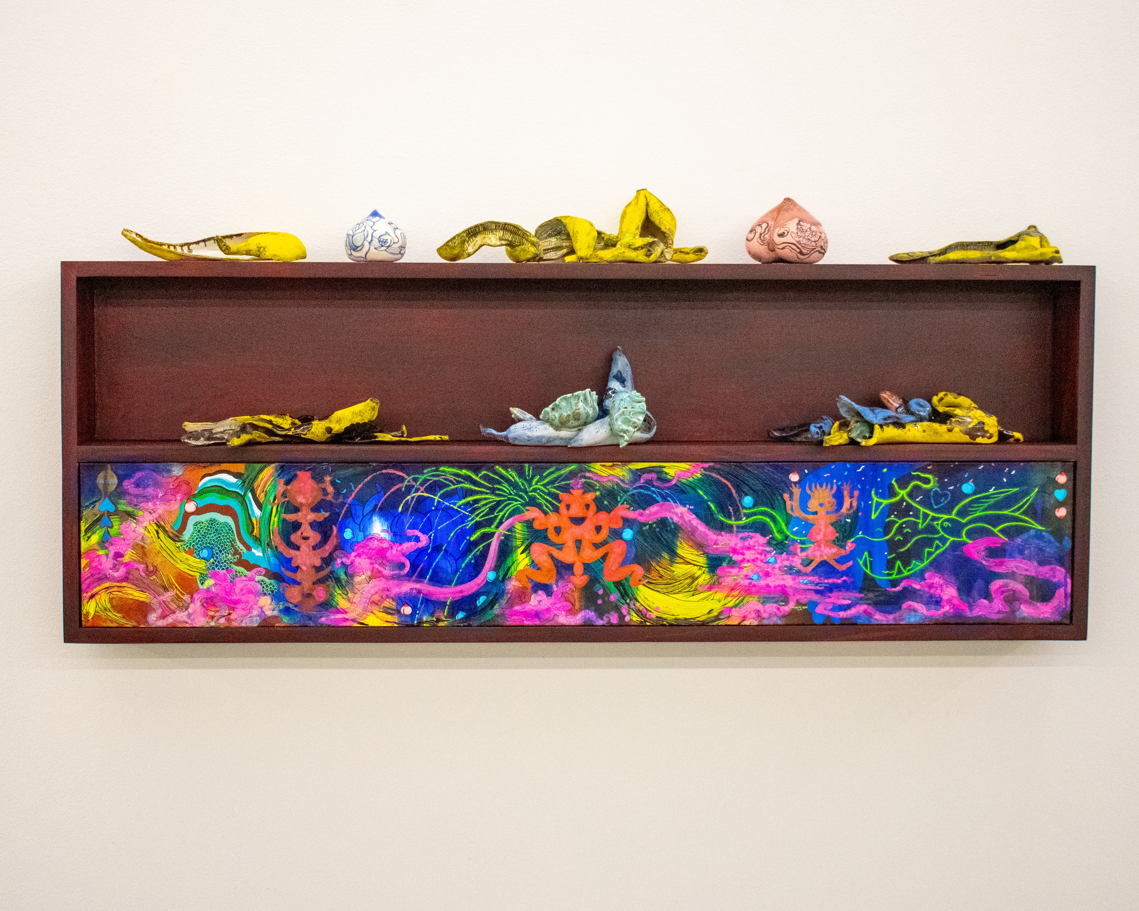 With "Moon Shrine," individual ceramics are placed on shelves affixed to larger painted worlds. (Courtesy of Kevin Storer)