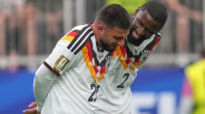 Germany's Deniz Undav, left, and Antonio Ruediger reacts after scoring the sixth goal during the World Cup Group E soccer match between Germany and Curacao in Houston, Sunday, June 14, 2026. (AP Photo/Eric Gay)