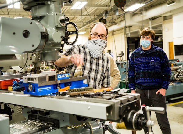 Georgia Northwestern Technical College in Rome, GA continues conducting classes, including precision machining and manufacturing labs, with smaller groups to allow for COVID-19 social distancing and with remote learning when possible Tuesday, Jan 26, 2021.  Instructor Bart Jenkins demonstrates a few basics for a class of new students including Trey Prater, right.  (Jenni Girtman for The Atlanta Journal-Constitution)