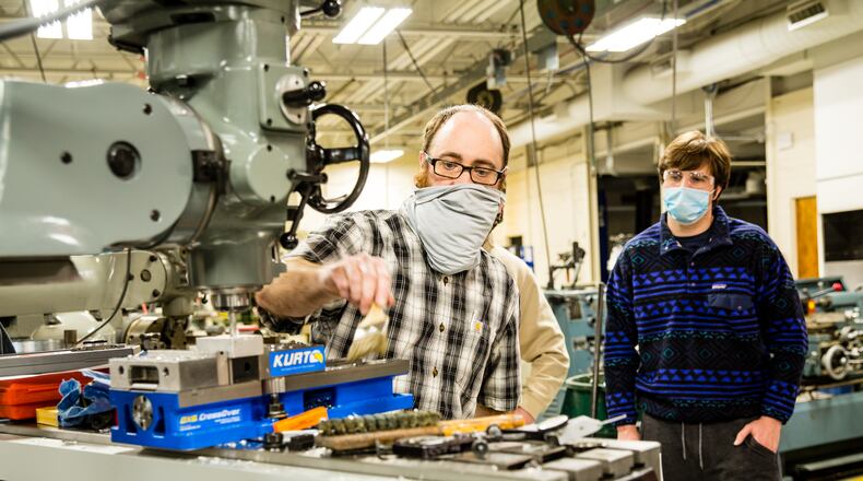 Georgia Northwestern Technical College in Rome, GA continues conducting classes, including precision machining and manufacturing labs, with smaller groups to allow for COVID-19 social distancing and with remote learning when possible Tuesday, Jan 26, 2021.  Instructor Bart Jenkins demonstrates a few basics for a class of new students including Trey Prater, right.  (Jenni Girtman for The Atlanta Journal-Constitution)