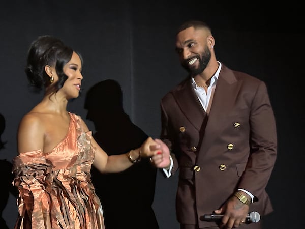 The stars of "Ruth & Boaz," Serayah McNeill (left) and Tyler Lepley, greet the audience at a screening of the Netflix film on Monday, Sept. 22, 2025, at Regal Atlantic Station in Atlanta. (Rodney Ho/AJC)