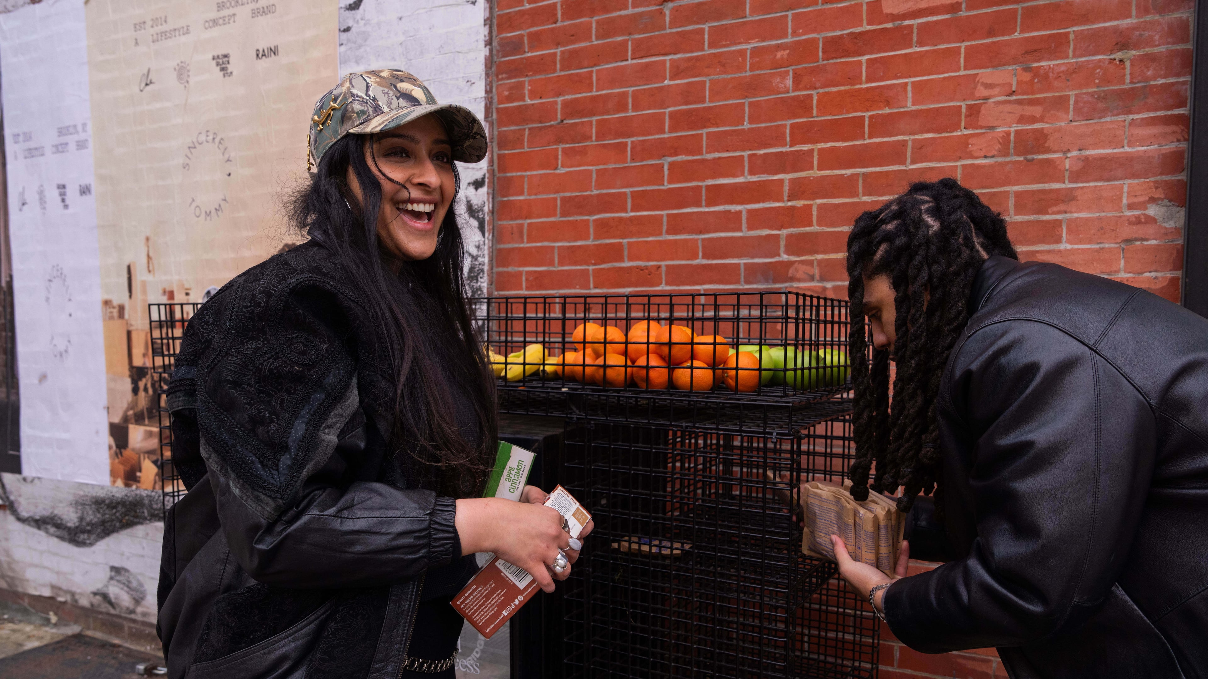 Kashish Ali and Elliott McKnight stock a One Love Community Fridge with food, Nov. 15, 2025, in Brooklyn, New York. (AP Photo/Adam Gray)