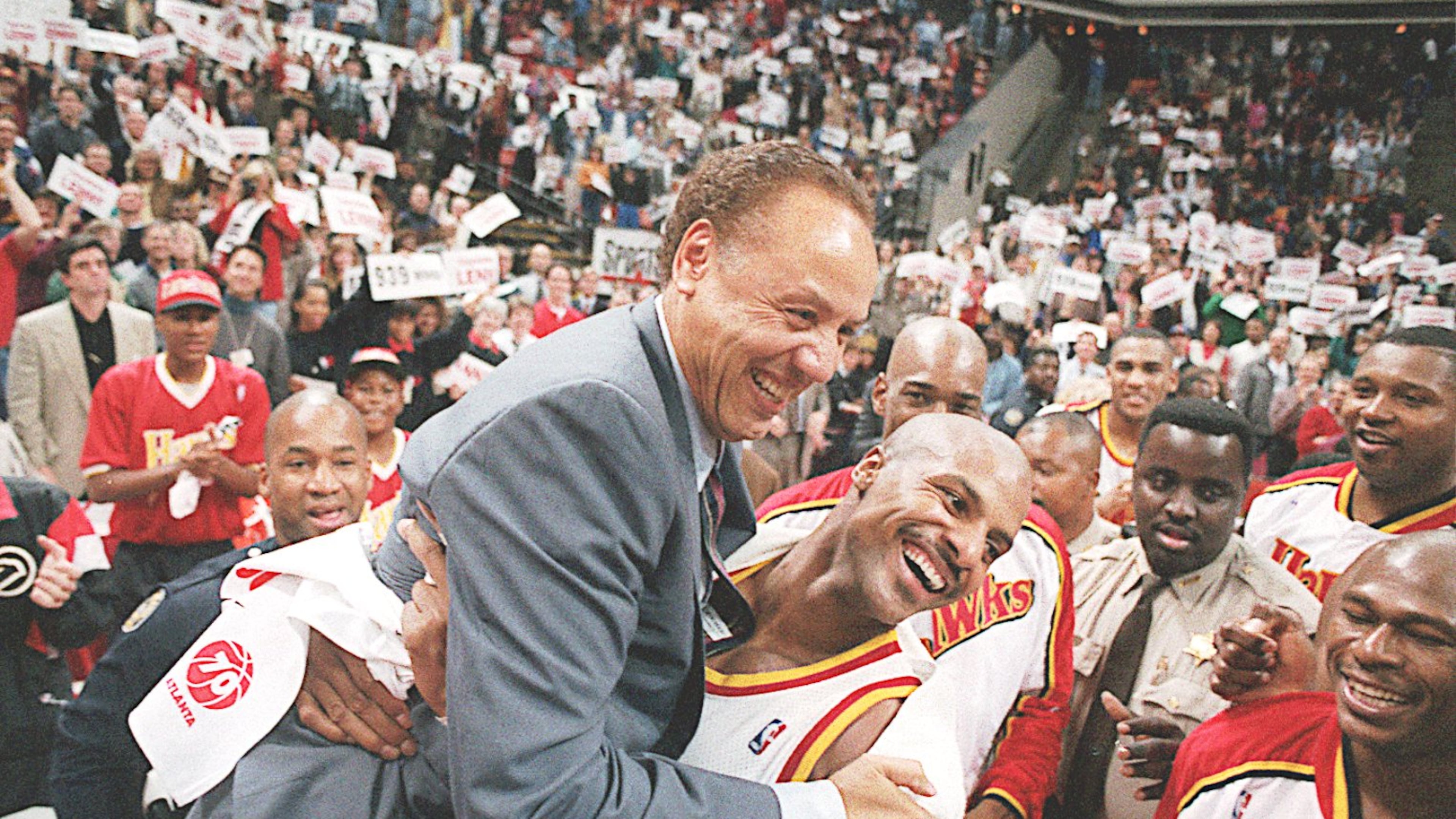 Hawks player Ken Norman (right) picks up Lenny Wilkens after the coach's record-breaking 939th career win in 1995. (AJC file photo)