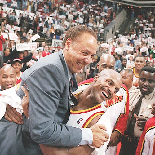 Hawks player Ken Norman (right) picks up Lenny Wilkens after the coach's record-breaking 939th career win in 1995. (AJC file photo)