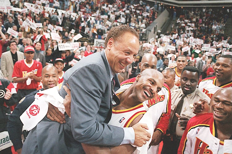 Hawks player Ken Norman (right) picks up Lenny Wilkens after the coach's record-breaking 939th career win in 1995. (AJC file photo)