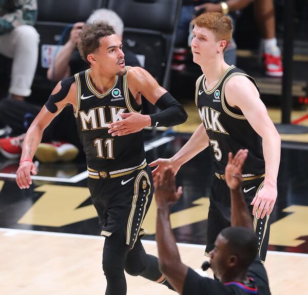 Hawks guards Trae Young and Kevin Huerter celebrate after a pass from Young to Huerter for a three-pointer.   “Curtis Compton / Curtis.Compton@ajc.com”