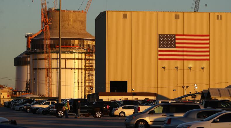 121421 Waynesboro: A construction entrance to Vogtle 3 & 4 (seen stacked at left) is full of worker's vehicles at sunset on Tuesday, Dec 14, 2021, in Waynesboro.   “Curtis Compton / Curtis.Compton@ajc.com”`