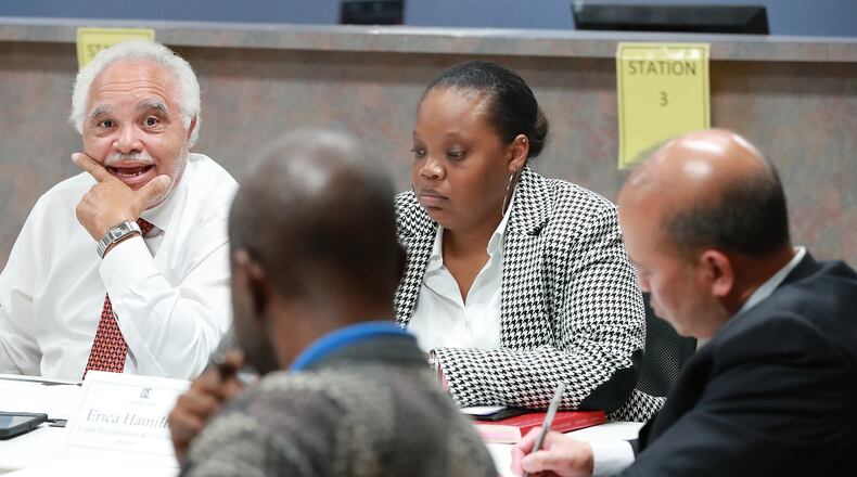 Nov 13, 2018 Decatur: DeKalb County Elections Board members Samuel Tillman (from left), Anthony Lewis, Erica Hamilton, Voter Registration and Elections Director, and Baoky Vu along with other board members vote unanimously to certify it's election results at the DeKalb County Elections office on Tuesday, Nov. 13, 2018, in Decatur.  Curtis Compton/ccompton@ajc.com