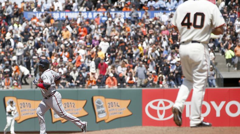 Giants pitcher Madison Bumgarner walks back onto the mound as Braves’ Juan Uribe runs the bases after hitting a two-run home run during the seventh inning, Sunday, May 31, 2015, in San Francisco. (AP Photo/Tony Avelar)