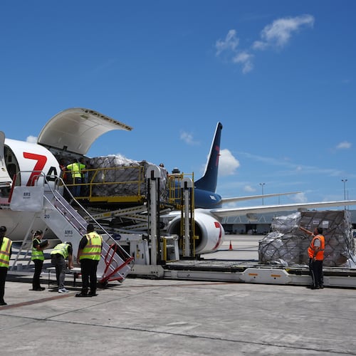 People load pallets containing food and hygiene kits for a humanitarian assistance flight to Cuba organized by the Trump administration as the U.S. continues to put pressure on the island's government, Tuesday, July 21, 2026, in Miami. (AP Photo/Lynne Sladky)