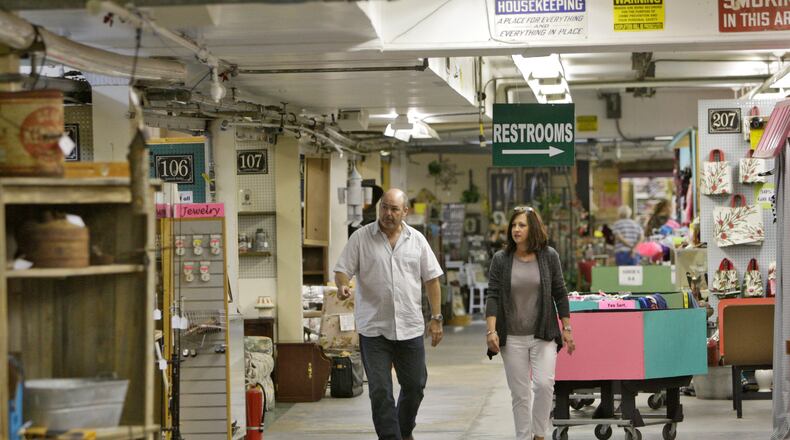 Walking down one of the former candy production lines, Neal Spradley, left, credits his wife, Rae, with converting the former Standard Candy Company into a successful flea market. Georgia has given millions in tax breaks and other goodies for employers who promised to create a specific number of jobs in the state over the last decade. But the state appears to have been very forgiving of companies that didn't hold up their end of the bargain.
