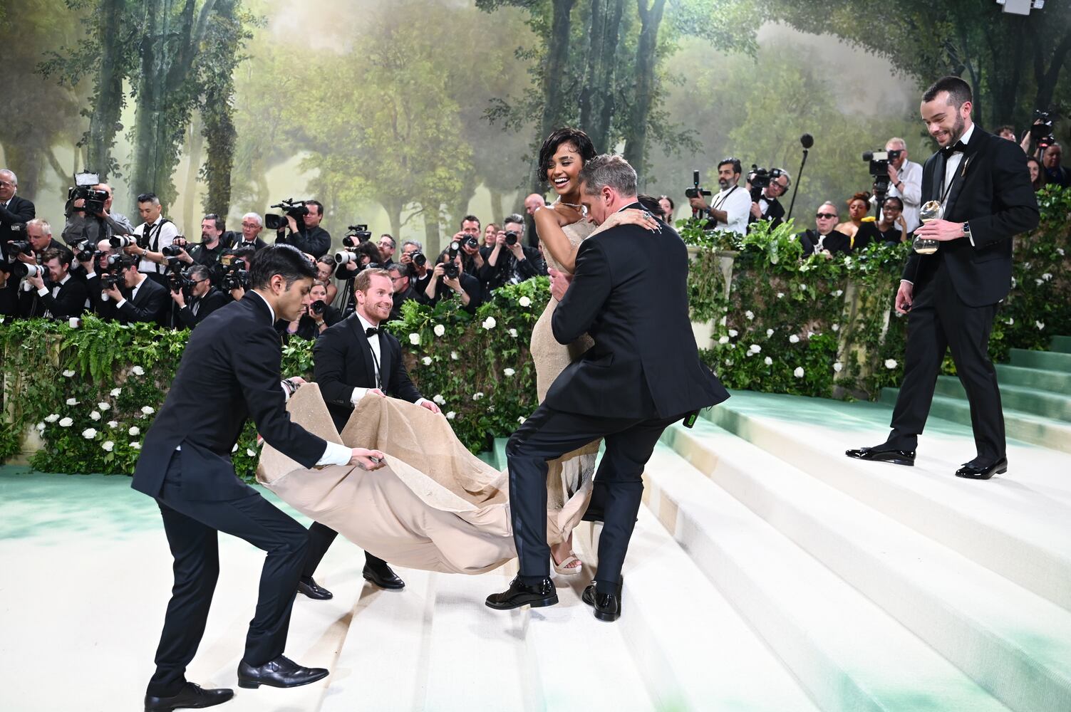 Tyla is helped up the stairs at the Metropolitan Museum of Art's Costume Institute benefit gala in New York, May 6, 2024. (Nina Westervelt/The New York Times)