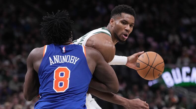 Milwaukee Bucks' Giannis Antetokounmpo tries to get past New York Knicks' OG Anunoby during the second half of an NBA basketball game Tuesday, Oct. 28, 2025, in Milwaukee. (AP Photo/Morry Gash)
