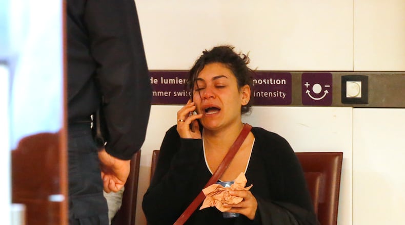A relative of the victims of the EgyptAir flight 804 reacts as she makes a phone call at Charles de Gaulle Airport outside of Paris, Thursday, May 19, 2016. Egyptian aviation officials say an EgyptAir flight from Paris to Cairo with 66 passengers and crew on board has crashed. (AP Photo/Michel Euler)