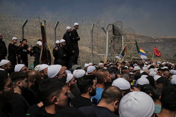 Druze from Syria and Israel protest on the Israeli-Syrian border, in Majdal Shams in the Israeli-controlled Golan Heights, Wednesday, July 16, 2025, amid the ongoing clashes between Syrian government forces and Druze armed groups in the southern Syrian city of Sweida. (AP Photo/Leo Correa)