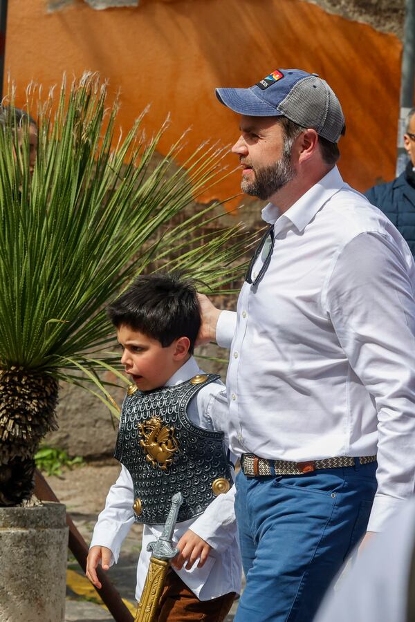 US Vice President J.D. Vance arrives with son Ewan wearing a gladiator toy set at Rome's Botanic Gardens, Saturday, April 19, 2025. (AP Photo/Riccardo De Luca)