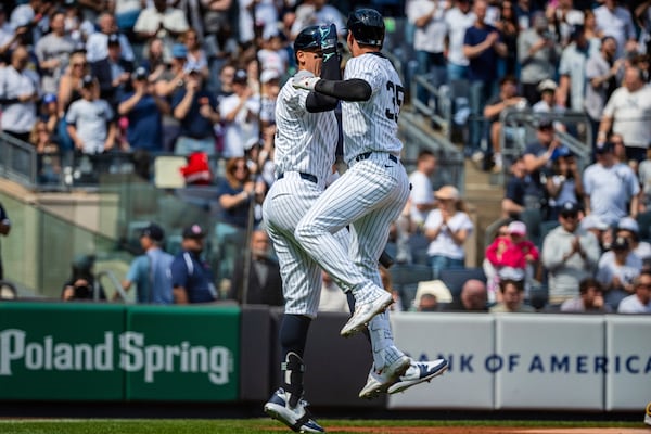 New York Yankee's Cody Bellinger (35) celebrates with Aaron Judge after hitting a home run during the first inning of baseball game against the Milwaukee Brewers, Saturday, March 29, 2025, in New York. (AP Photo/Angelina Katsanis)