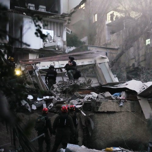 Israeli security forces and rescue teams work amid the rubble of a residential building struck by an Iranian missile in Haifa, Israel, Sunday, April 5, 2026. (AP Photo/Ariel Schalit)