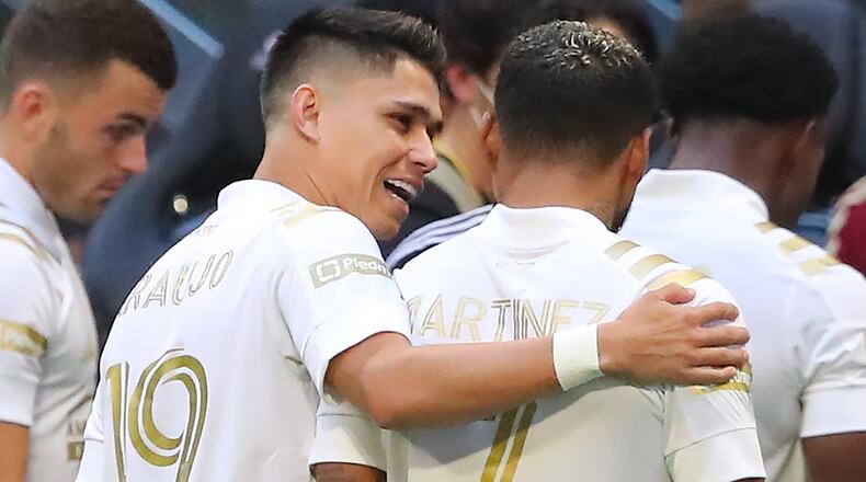 Atlanta United forward Luiz Araujo (left), playing his first game with the team, emrbraces Josef Martinez (7) as they take the field to play Toronto FC Wednesday, Aug. 18, 2021, at Mercedes-Benz Stadium in Atlanta. (Curtis Compton / Curtis.Compton@ajc.com)