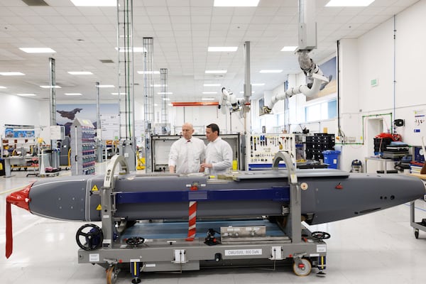 Director of Mechanical Engineering Matt Beamont, right, shows Britain's Defence Secretary John Healey a storm shadow missile on an assembly line at the MBDA Storm Shadow factory in Stevenage, England, Saturday May 31, 2025. (Dan Kitwood/Pool via AP)