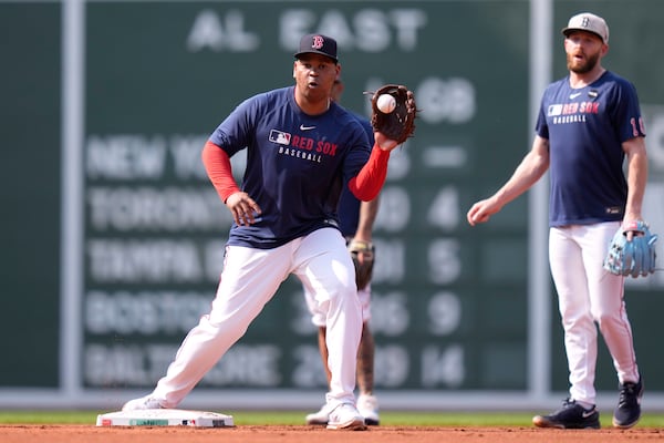 Boston Red Sox designated hitter Rafael Devers, center, takes infield practice with teammates prior to a baseball game against the Tampa Bay Rays at Fenway Park, Wednesday, June 11, 2025, in Boston. (AP Photo/Charles Krupa)