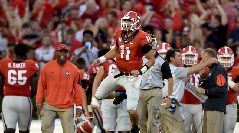 Georgia quarterback Greyson Lambert celebrates after connecting with wide receiver Malcolm Mitchell for a touchdown against South Carolina. (Brant Sanderlin, bsanderlin@ajc.com)